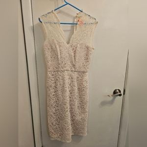 White lace dress with pink underlayment